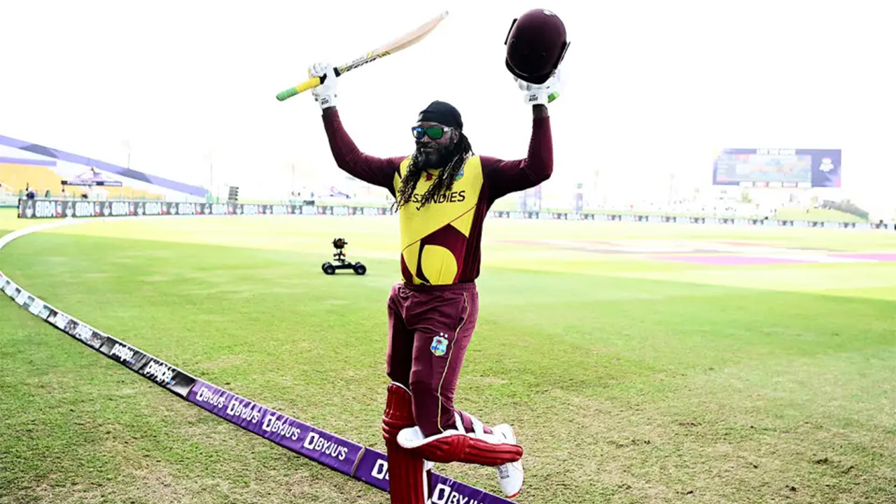 Chris Gayle Raises His Bat As He Steps Off The Field