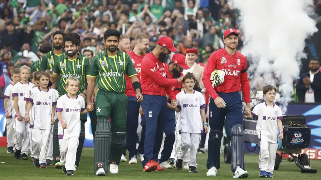 Babar Azam and Jos Buttler lead their teams out for the national anthems