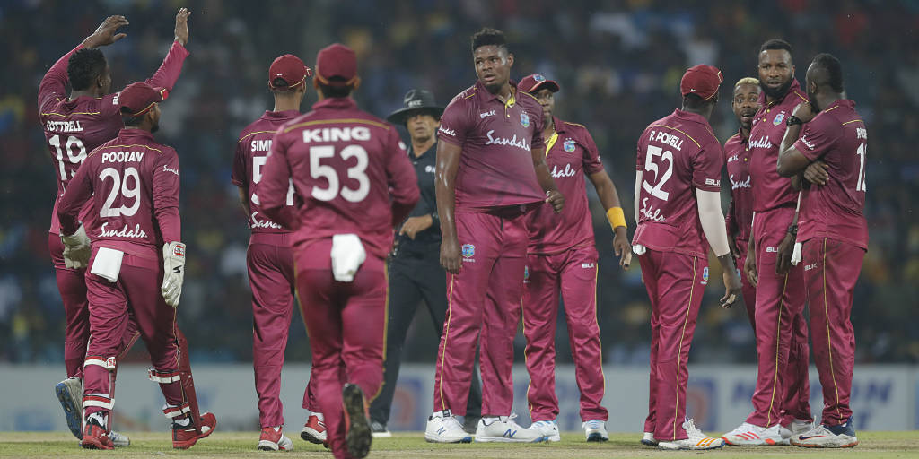 West Indies' bowler Oshane Thomas, center, celebrates the dismissal of Sri Lanka's Dasun Shanaka with team mates during their first Twenty20 cricket match in Pallekele, Sri Lanka, Wednesday, March 4, 2020. (AP Photo/Eranga Jayawardena)