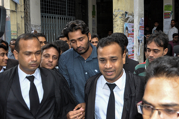 Bangladeshi cricketer Shahadat Hossain (C) walks outside a court in Dhaka on November 6, 2016. A Bangladesh court November 6 acquitted cricketer Shahadat Hossain and his wife on charges of torturing an 11-year-old girl whom he employed as a maid, a prosecutor said. / AFP / - (Photo credit should read -/AFP via Getty Images)