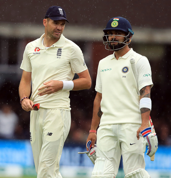 England's James Anderson chats to India's Virat Kohli as they walk off for rain stoppage during day two of the Specsavers Second Test match at Lord's, London. (Photo by Adam Davy/PA Images via Getty Images)