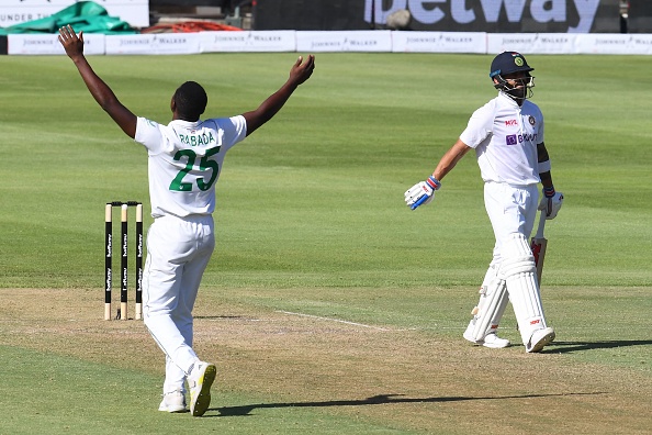 South Africa's Kagiso Rabada (L) celebrates after the dismissal of India's Virat Kohli (R) during the first day of the third Test cricket match between South Africa and India at Newlands stadium in Cape Town on January 11, 2022. (Photo by RODGER BOSCH / AFP) (Photo by RODGER BOSCH/AFP via Getty Images)