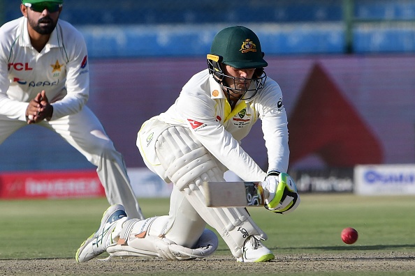 Australia's wicketkeeper Alex Carey (R) plays a shot during the second day of the second Test cricket match between Pakistan and Australia at the National Cricket Stadium in Karachi on March 13, 2022. (Photo by ASIF HASSAN / AFP) (Photo by ASIF HASSAN/AFP via Getty Images)
