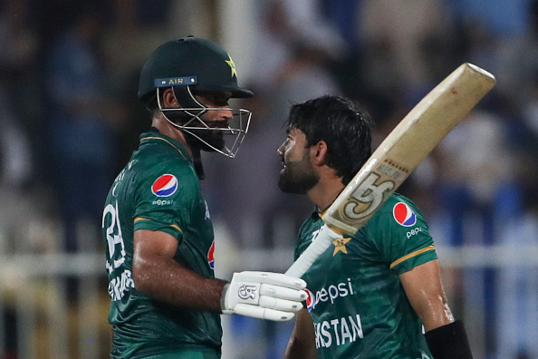 Pakistan's Fakhar Zaman (L) celebrates with teammate Mohammad Rizwan afer scoring his half-century (50 runs) during the Asia Cup Twenty20 international cricket match between Pakistan and Hong Kong at the Sharjah Cricket Stadium in Sharjah on September 2, 2022. (Photo by Surjeet Yadav / AFP) (Photo by SURJEET YADAV/AFP via Getty Images)