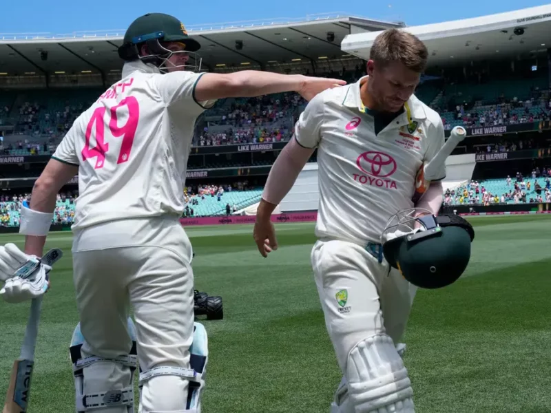 David Warner receiveing a pat on the back from Steve Smith